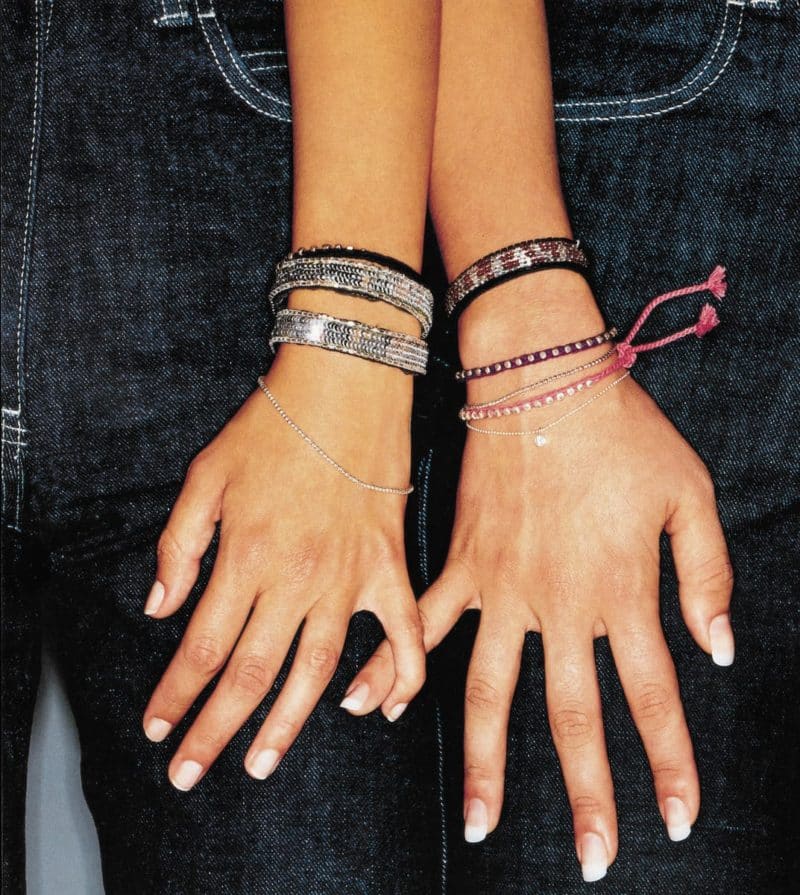 two manicured hands with bracelets
