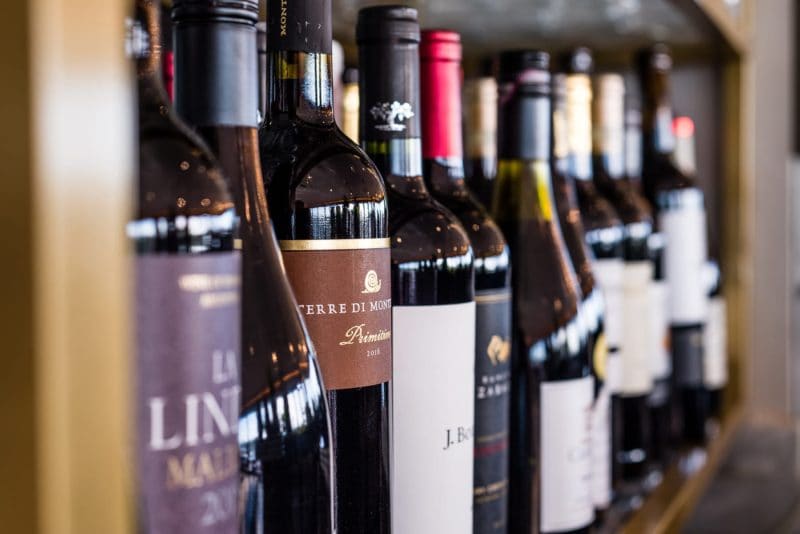 Bottles of Wine aligned in a shelf at Six Cocktail Bar in Cambridge